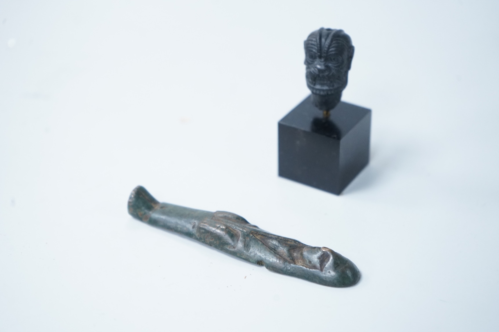 Two small antiquities with certificates - an Assyrian obsidian head of Pazuzu and a Celtic bronze offer idol